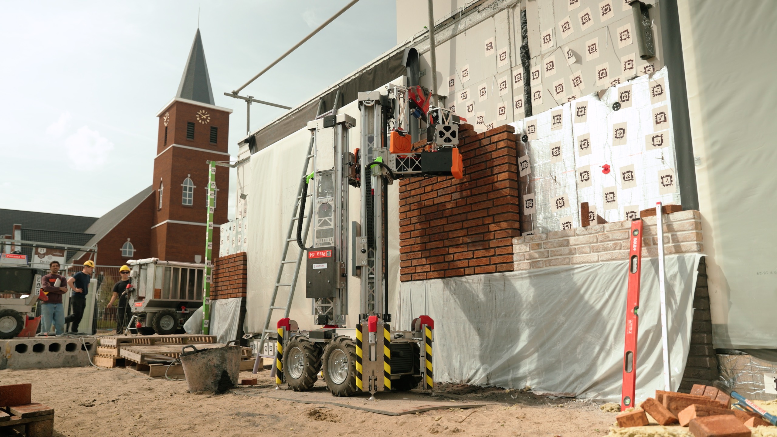 A Monumental robot laying a brick facade on a Dutch construction site, a village church rising behind it